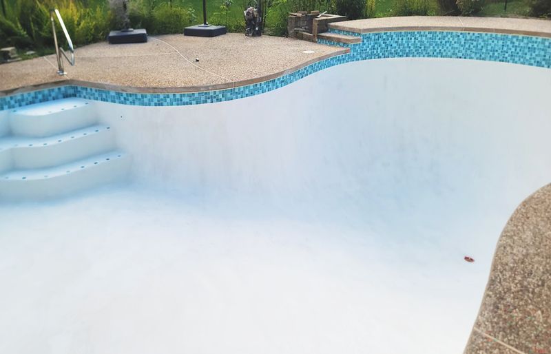 Pool tile restoration with new glass tile