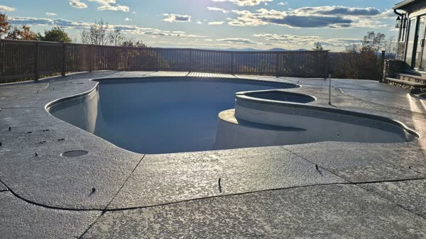 Finished pool closeup showing tile detail and crystal clear water