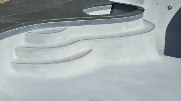 Freshly plastered pool step detail with mosaic tile