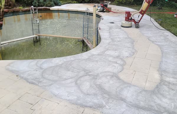 Crew resurfacing and applying deck overlay